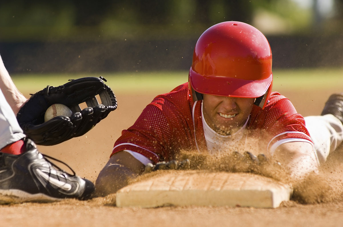 What should baseball do about wet bases and the injuries they can cause